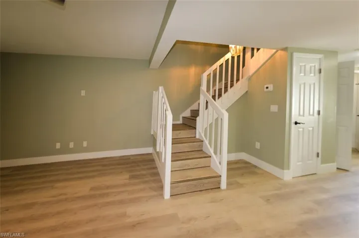 Stairs featuring laminate wood look flooring