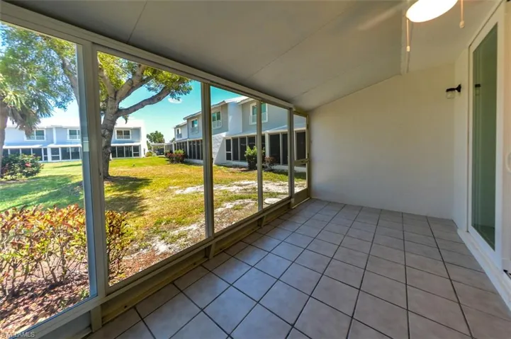 Unfurnished sunroom featuring a healthy amount of sunlight and ceiling fan