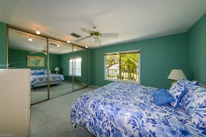 Bedroom with a closet, carpet, and ceiling fan