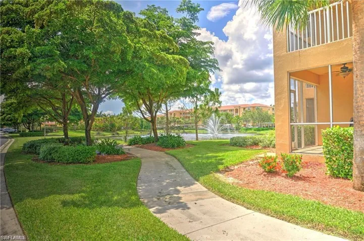 View of community featuring a lawn, a balcony, and a sunroom