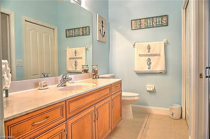 Half bathroom featuring light tile patterned floors and vanity