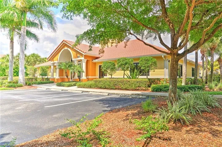 View of property featuring uncovered parking