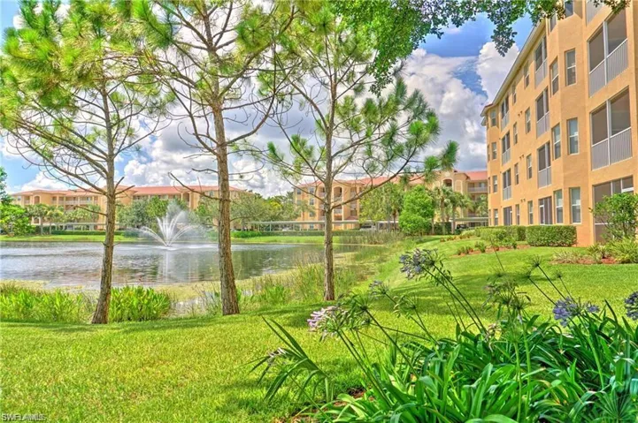 Surrounding community featuring a lawn and a water view