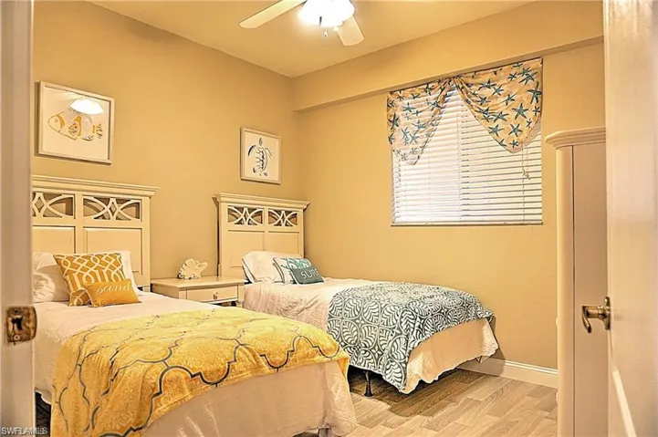 Bedroom with light wood-type flooring and a ceiling fan