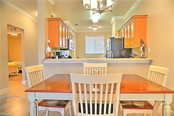 Dining area with a chandelier and crown molding