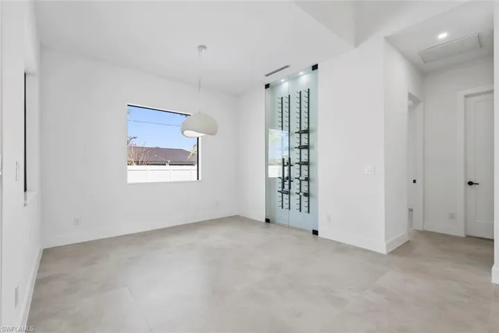 Unfurnished room with baseboards, concrete floors, and recessed lighting