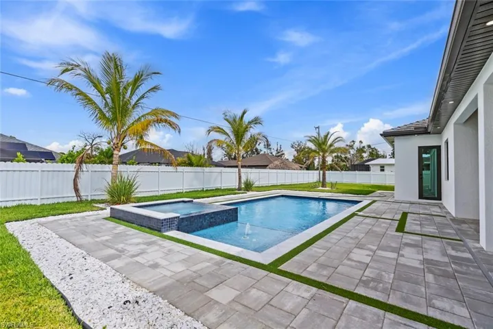 View of swimming pool featuring a patio area and a pool with connected hot tub