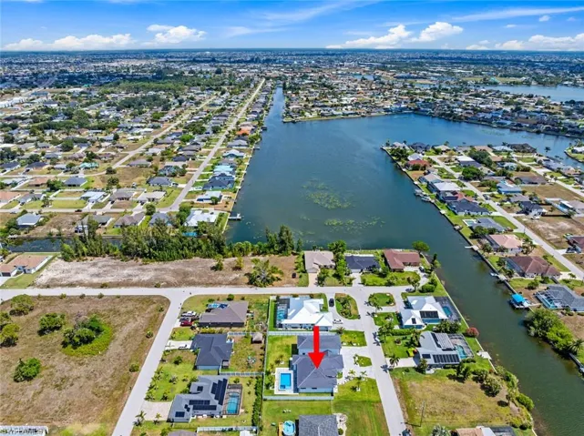 Aerial perspective of suburban area featuring a large body of water