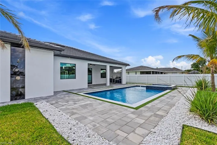 View of swimming pool with a fenced backyard, a patio area, and ceiling fan