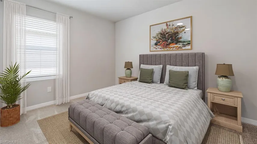 This image is virtually staged. Carpeted bedroom featuring baseboards