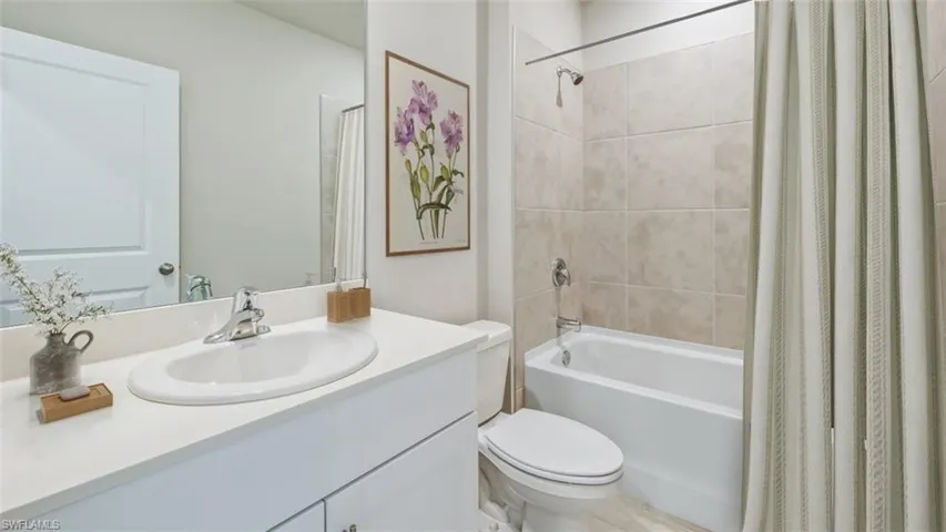 This image is virtually staged. Bathroom with vanity and shower / bath combination with curtain