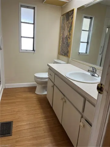 Bathroom featuring a wealth of natural light and wooden walls