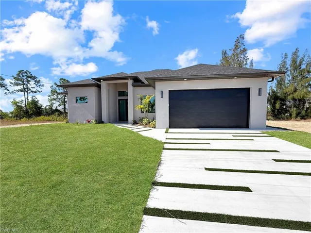 Modern stucco exterior with a dark garage door