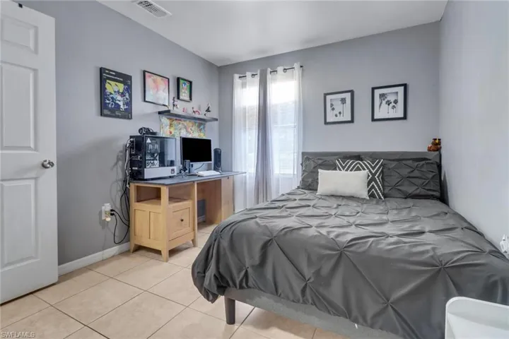 Bedroom featuring visible vents, baseboards, and light tile patterned floors