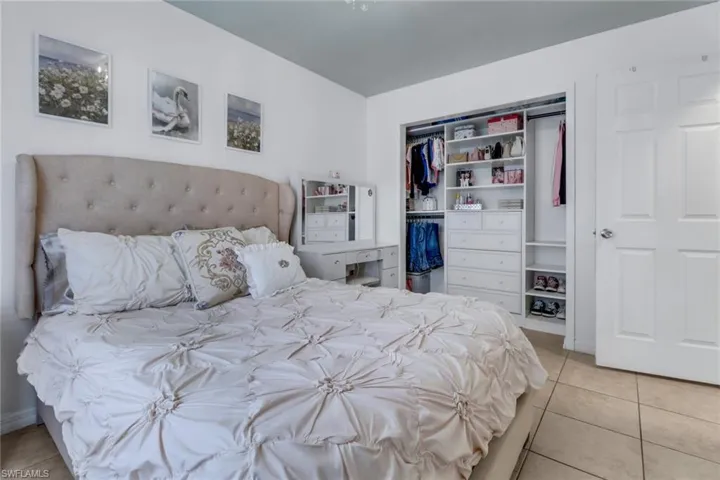 Tiled bedroom featuring a closet