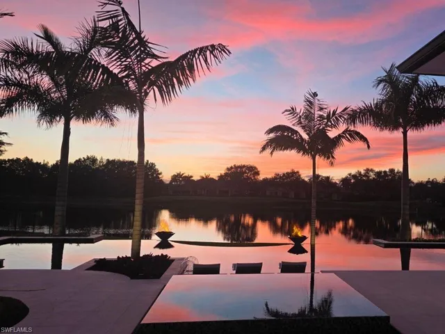 Infinity edge pool and spa with sunset overlooking the lake