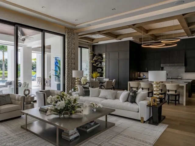 Living room with coffered ceiling and light wood-type flooring