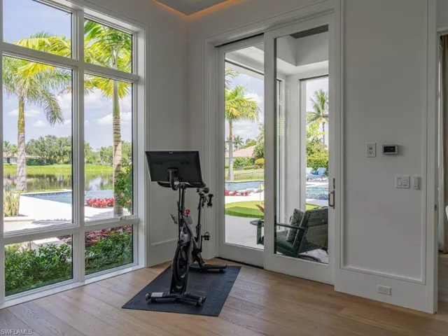 Workout area featuring picture window and access to pool