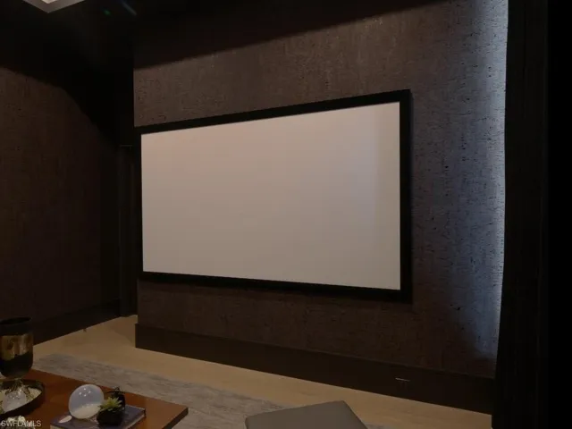 Home theater featuring projection screen, and black out curtains