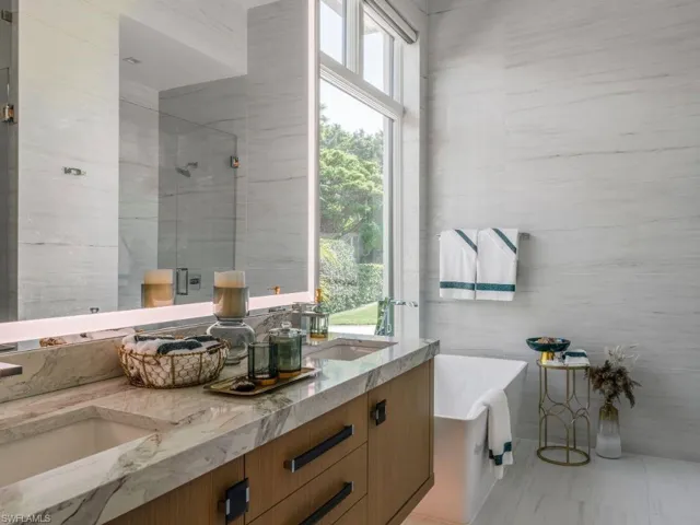 Dual vanity, private water closet, separate shower and tub with tile walls