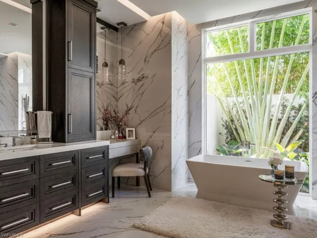 Primary bathroom with vanity, and dressing area, a soaking tub, and towel warmer