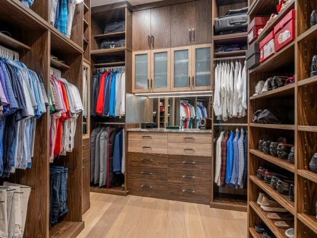 Primary walk in closet 2 with light wood-style floors