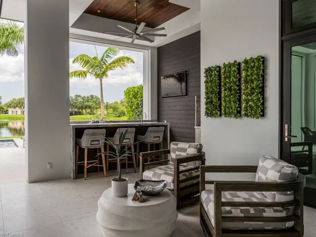 Outdoor kitchen and outdoor lounge area with bar, and a Western water view