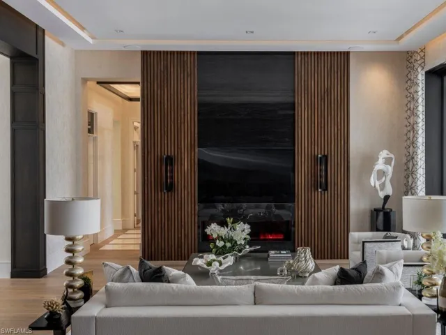 Living area with walnut slated and large format stone feature wall