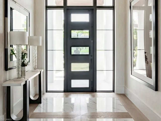 Grand foyer with wood floors and inlayed tiles