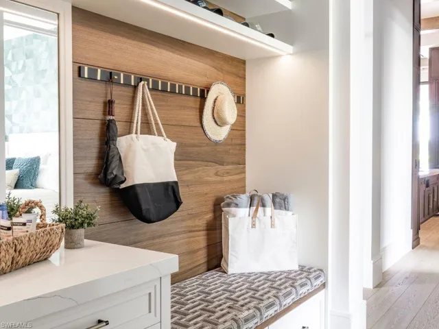 Hallway shoe drop with wooden slatting and mirror