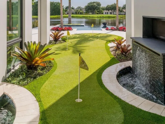 Putting green with 2 water features with views of the pool and lake