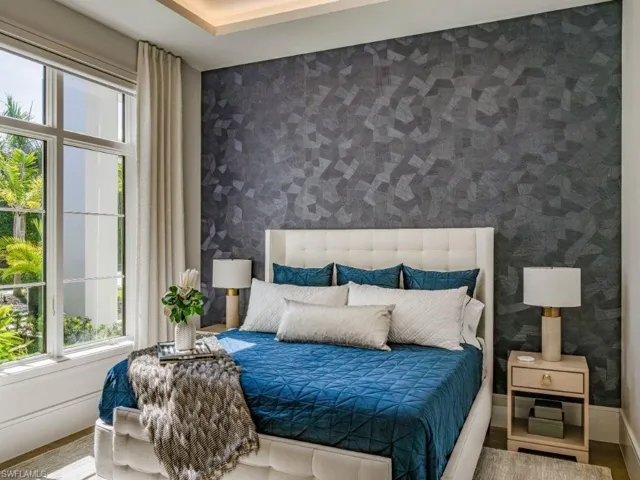 Bedroom 3featuring wallpapered wall and wood finished floors