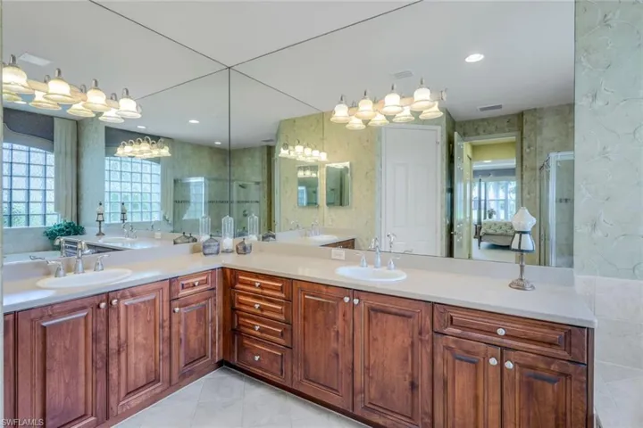 Bathroom with tile flooring, oversized vanity, and double sink