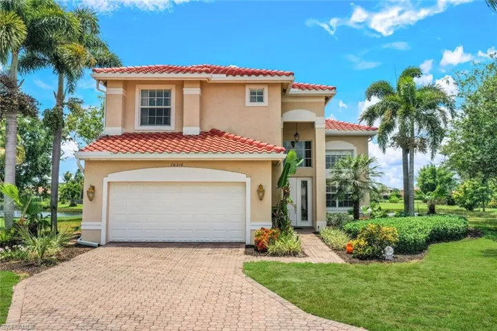 Mediterranean / spanish-style home featuring a garage and a front lawn
