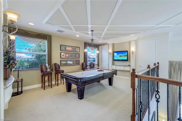 Recreation room with coffered ceiling, light colored carpet, and pool table
