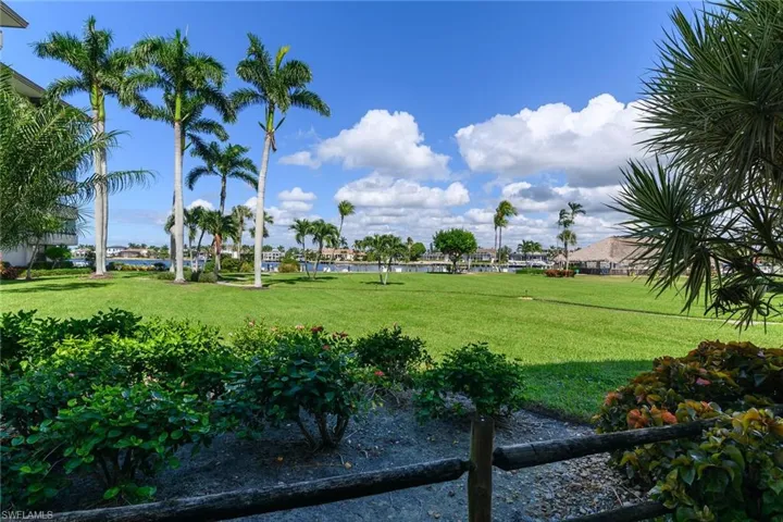 View of home's community featuring a water view and a yard