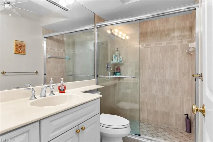 Full bathroom featuring a stall shower and vanity