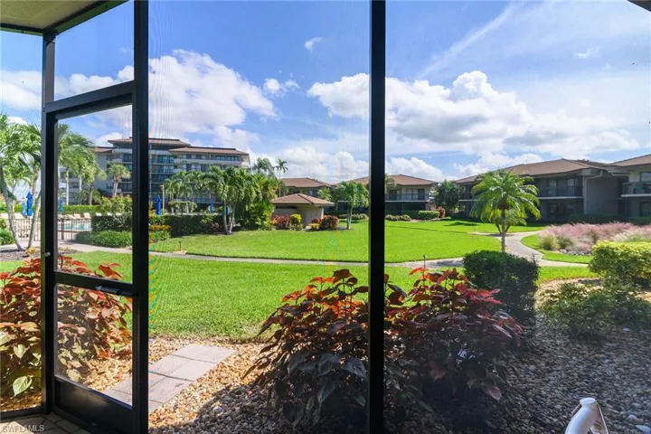View of green lawn featuring a sunroom