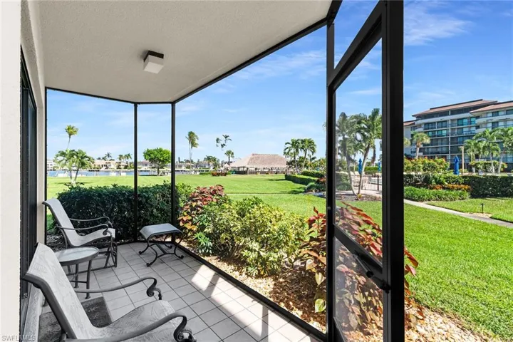 Sunroom featuring a water view