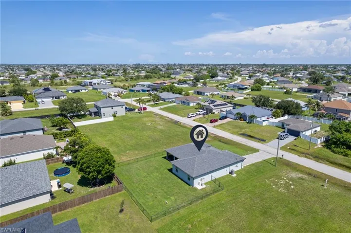 Aerial view of property's location with nearby suburban area