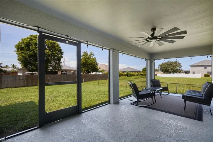 Sunroom / solarium with a ceiling fan and a patio area