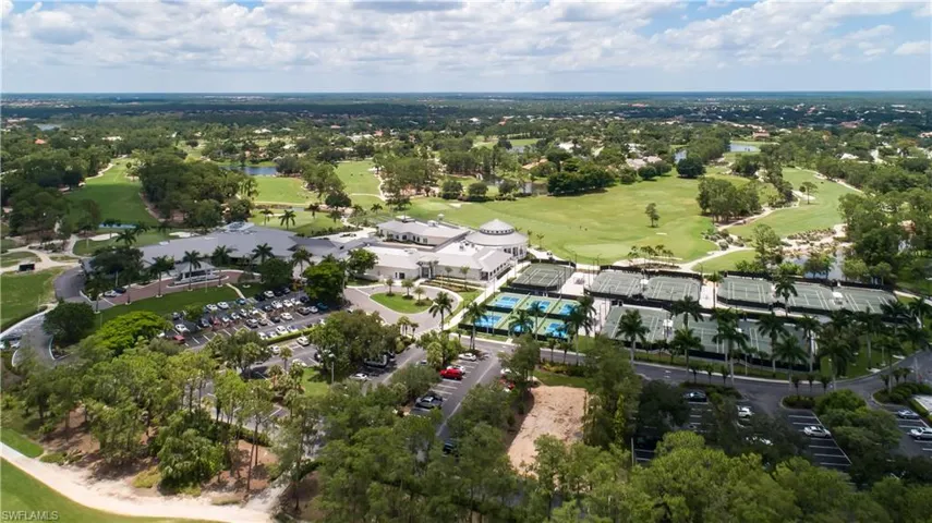 Aerial overview of property's location featuring a golf course and a nearby body of water