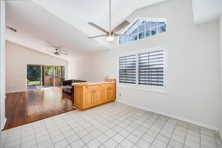 Kitchen with light tile patterned floors, vaulted ceiling, and ceiling fan