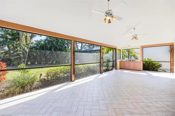 Unfurnished sunroom with ceiling fan
