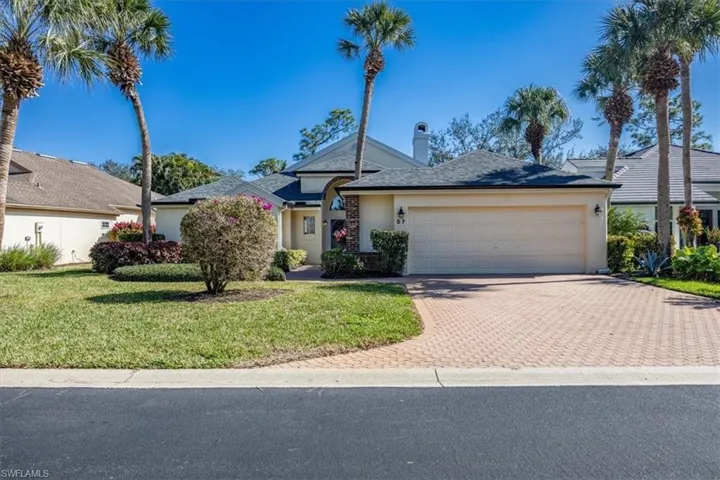 Single story home with a front yard and a garage