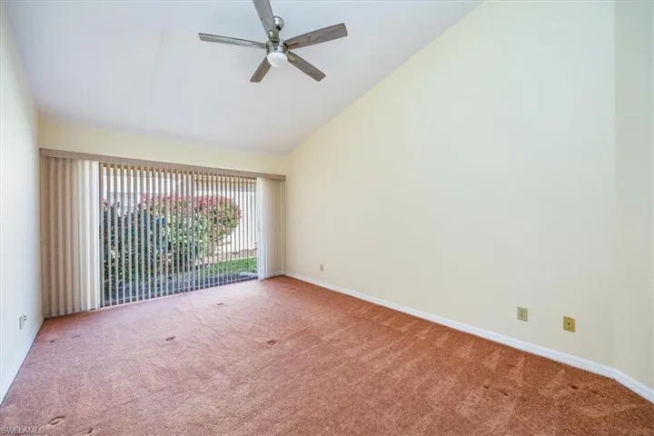 Unfurnished room with carpet floors, vaulted ceiling, and ceiling fan