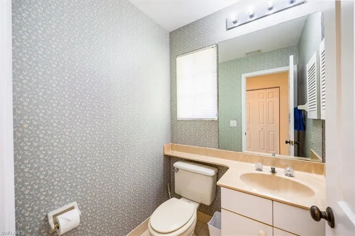 Bathroom with tile patterned flooring, vanity, and toilet