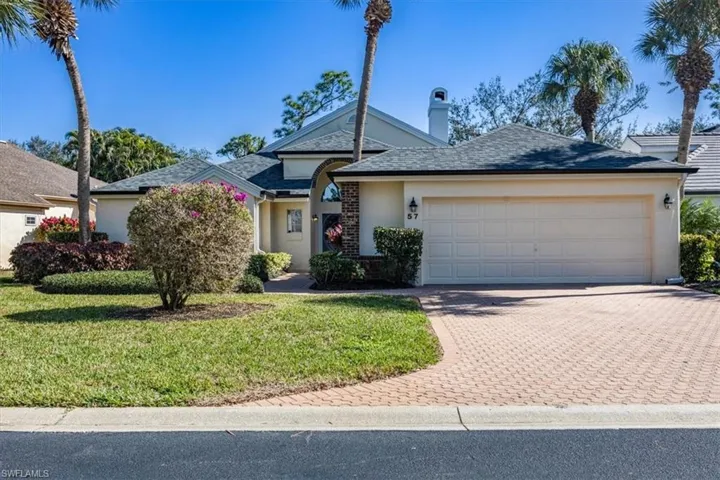 Single story home featuring a garage and a front yard