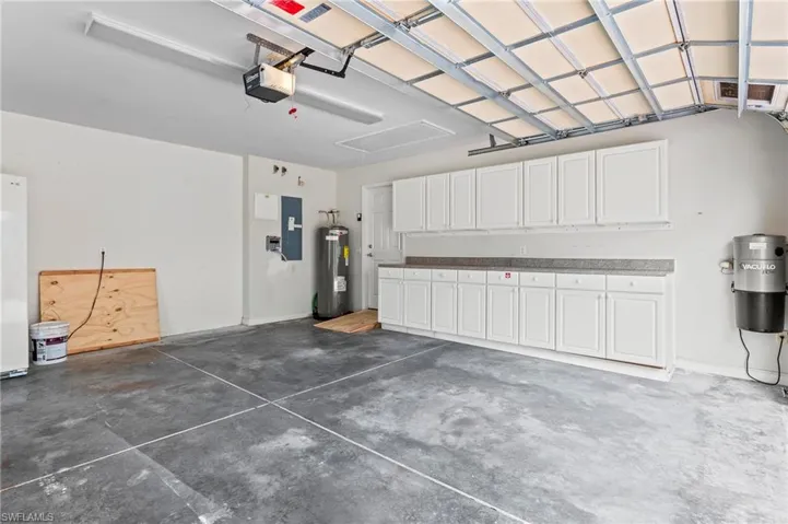 28864 Yellow Fin Trail Bonita Springs FL 34135 - Garage features insulated garage door, and additional storage cabinets.