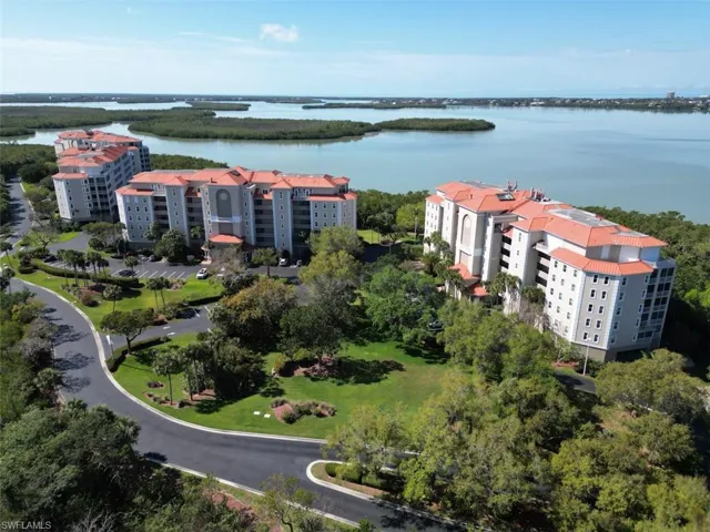 Aerial view of apartment complex and a large body of water